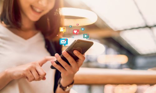 Social media and digital online concept, smiling Asian woman using smartphone and show technology icon.